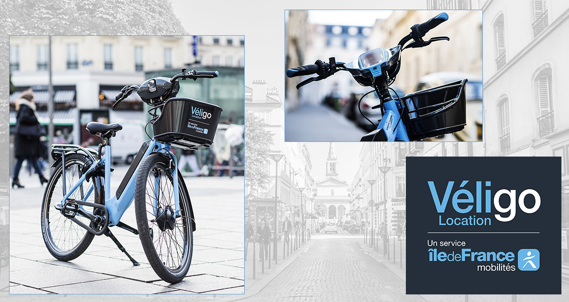 Montage avec le vélo électrique Véligo, un focus sur l'avant du cadre (guidon et panier) et le logo Véligo Location.