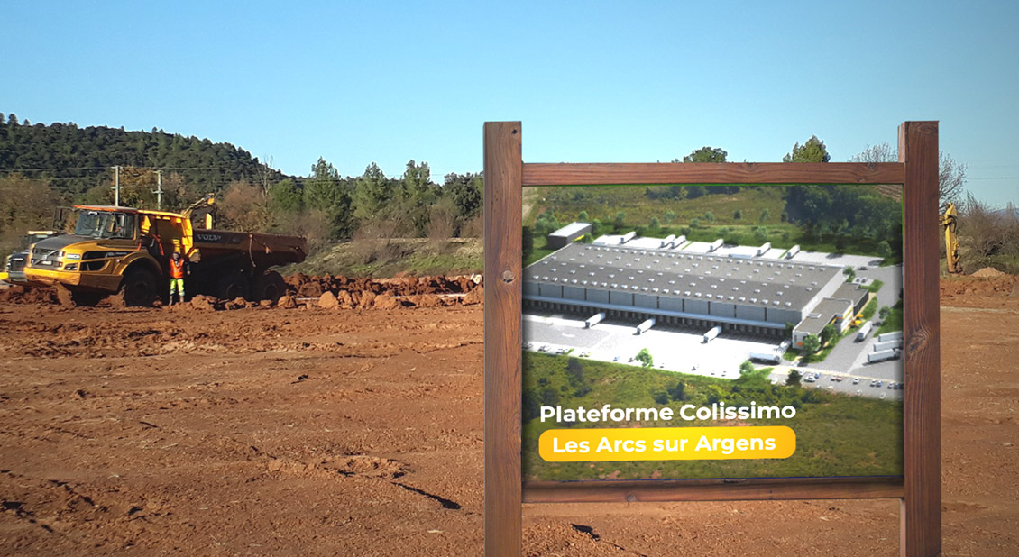 Photo of The project site after clearing, with a sign giving an idea of the scale of the site after construction.