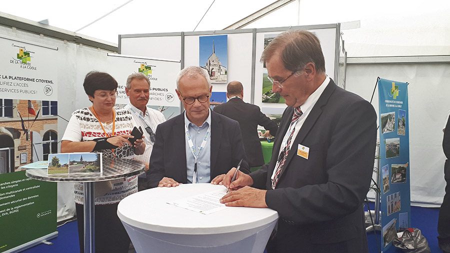 Photo de la signature de la convention entre la communauté de communes de la Moivre à la Coole et Docaposte, lors du Carrefour des élus à la foire de Châlons-en-Champagne.