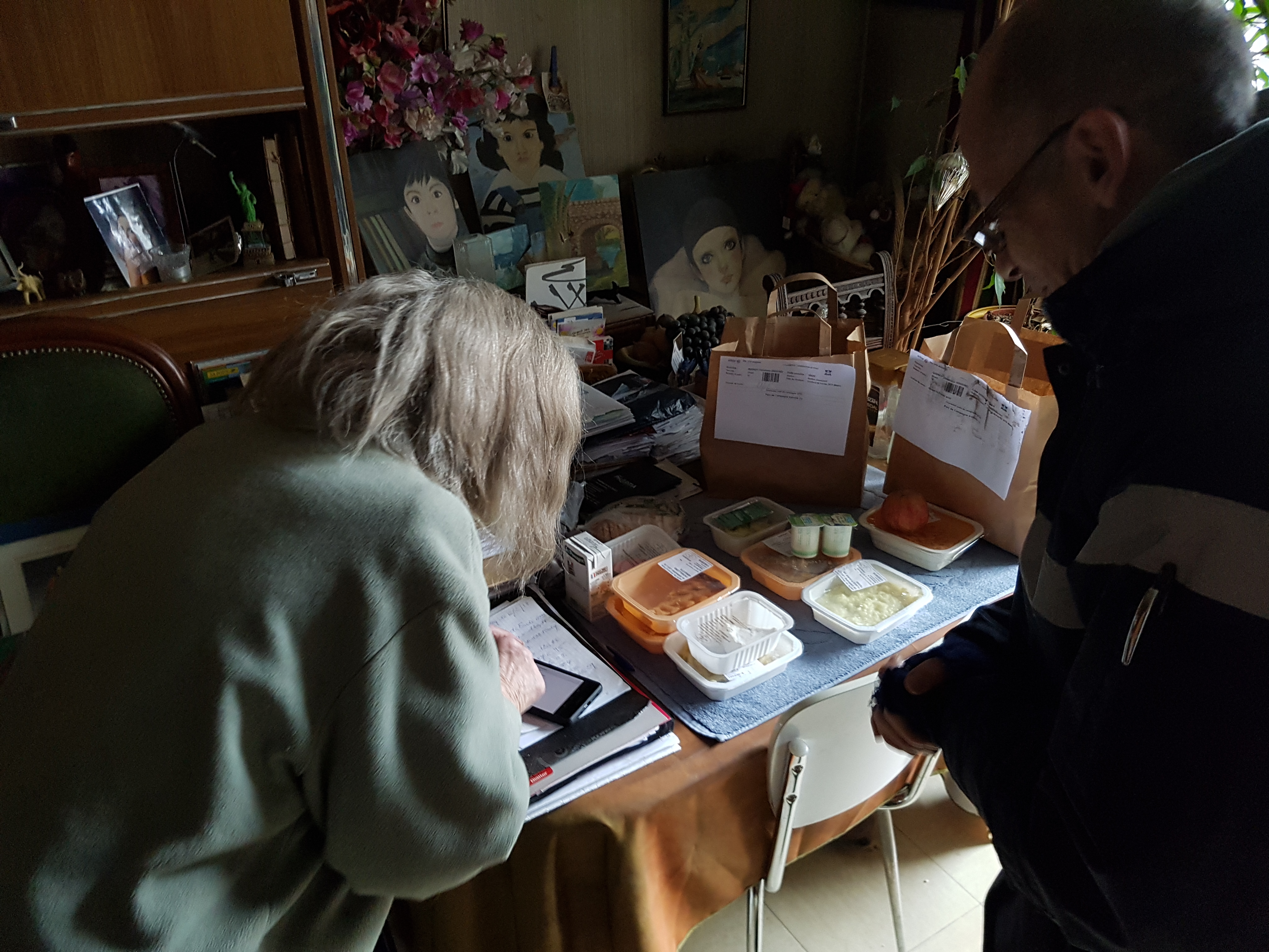 An employee carrying a meal as part of the “Enjoy at Home” service